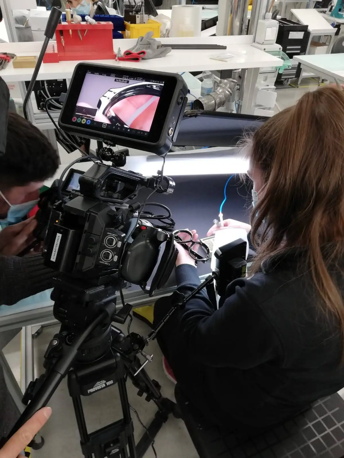 Cinema camera and monitor set up beside a workbench during a Dior shoot in an Italian workshop