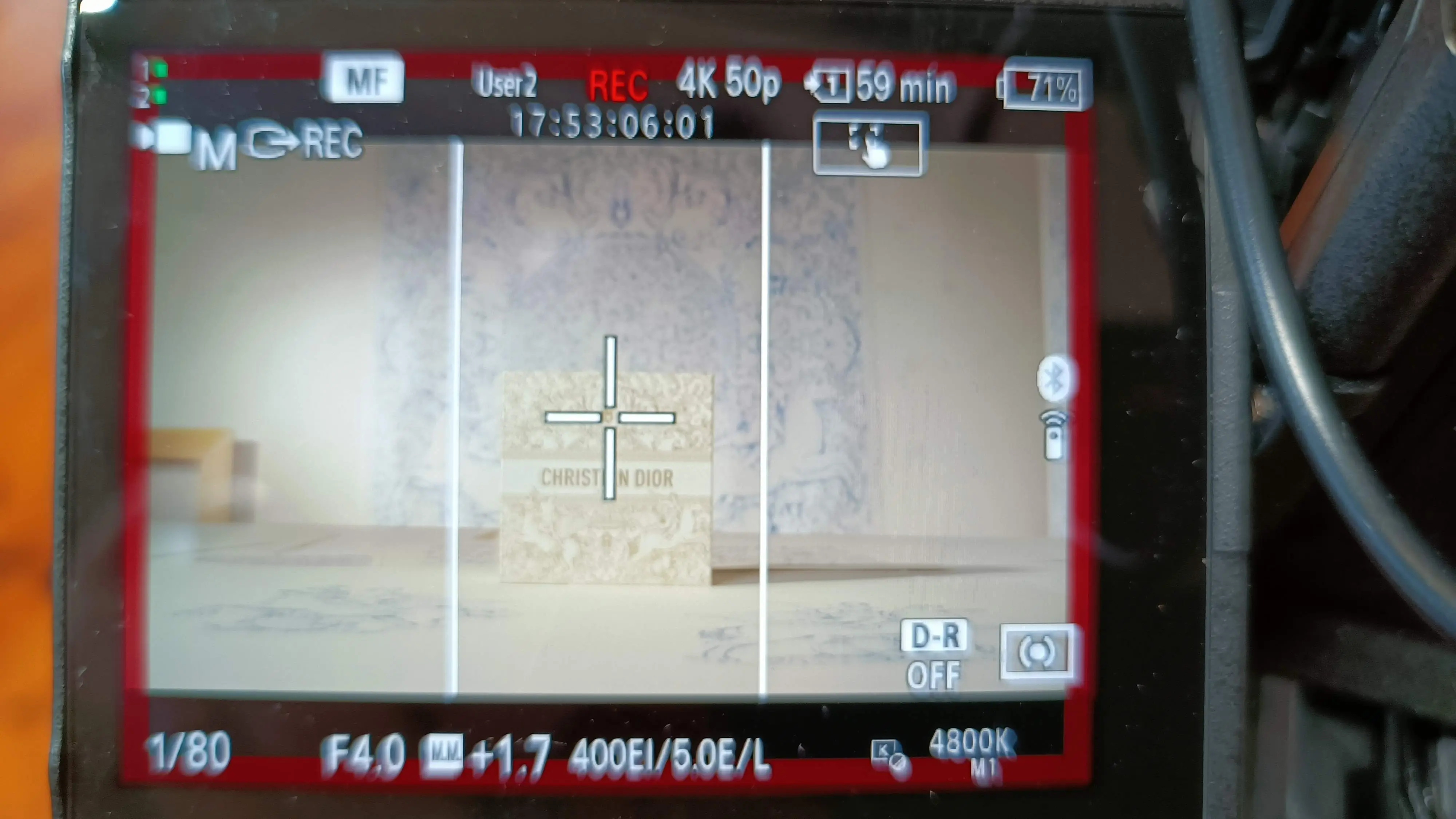 Field monitor showing hand-drawn artwork being filmed in an artist's studio on a Dior shoot