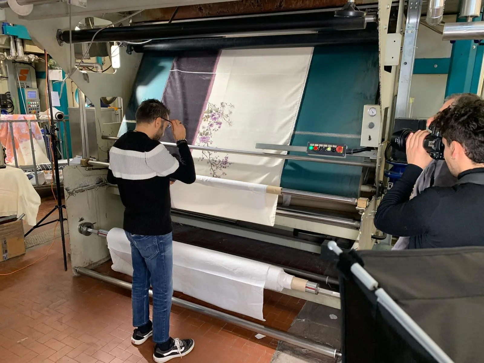 Filming an embroidered fabric running through a textile machine on a Dior savoir-faire shoot