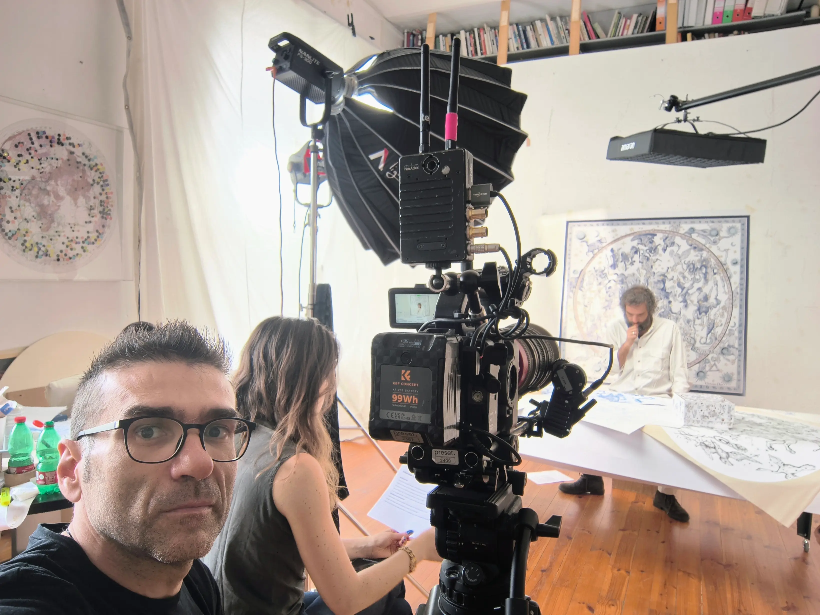 Matteo Castelli with the crew and lighting rigged in the artist Pietro Ruffo's studio on a Dior shoot