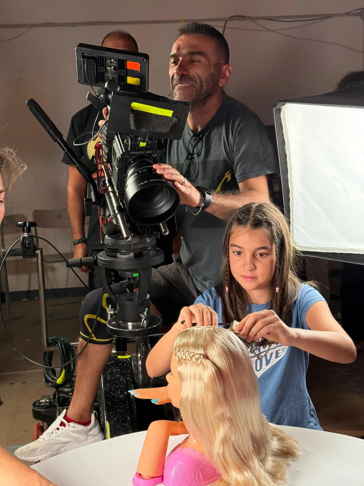 Matteo Castelli operating a cinema camera with a Zeiss Makro-Planar lens on a toy commercial with a young performer