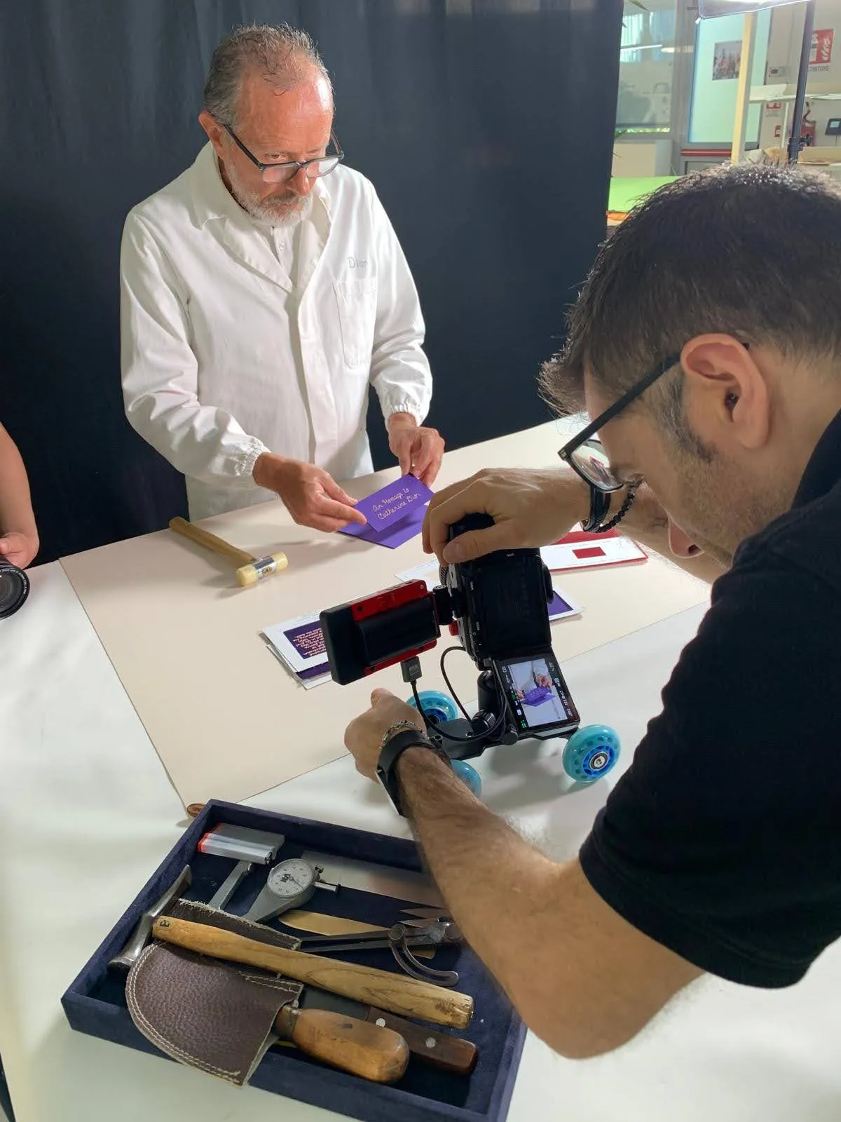 Matteo Castelli filming a Dior artisan at work on a camera slider, with craft tools laid out on the bench