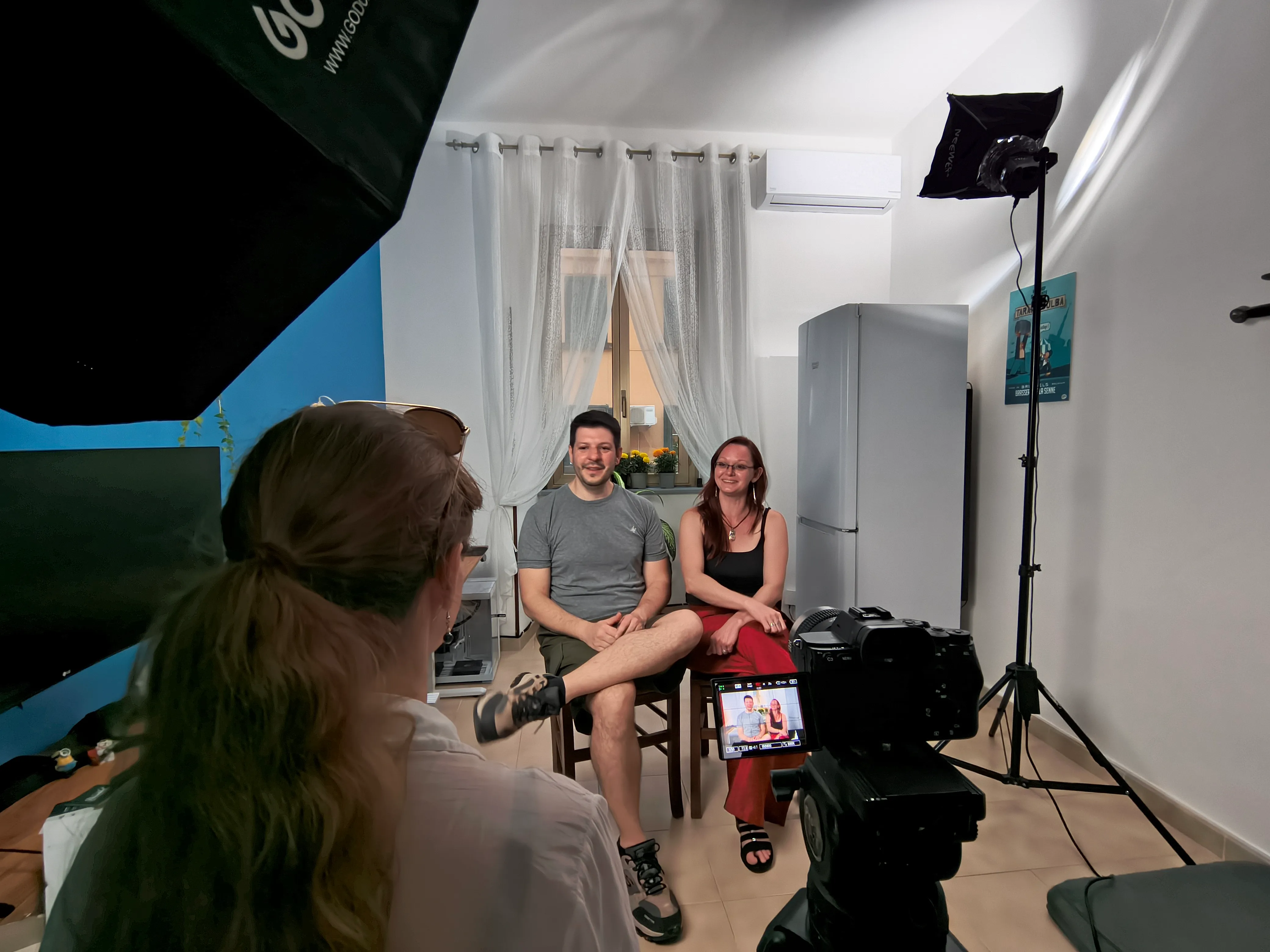Interview with a couple at home lit with a softbox, the interviewer seated off camera, for a Smart Move Italy documentary
